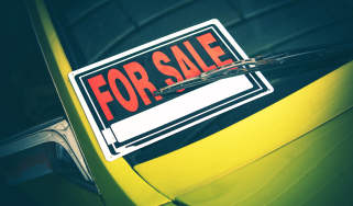'For sale' sign on car windscreen